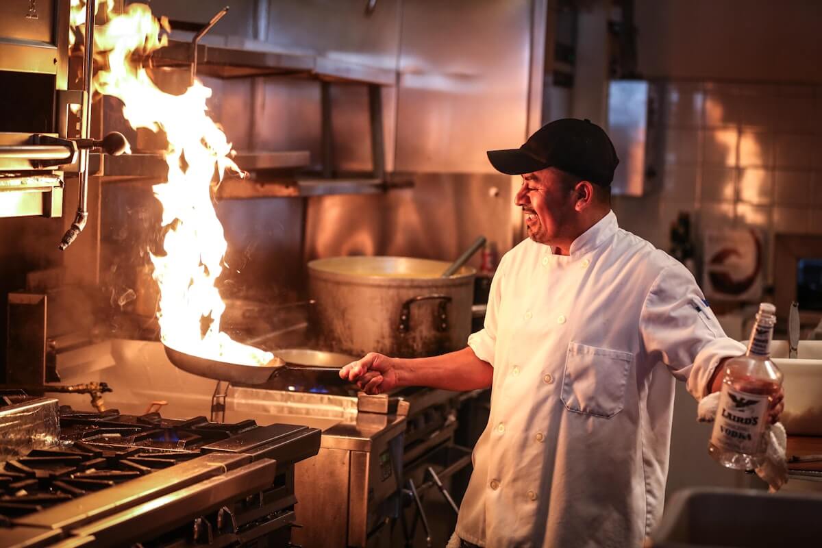 Fine dining hotel kitchen ESP with odor control — chef flambé cooking in Michelin-grade kitchen requiring low-noise ESP and activated carbon filtration