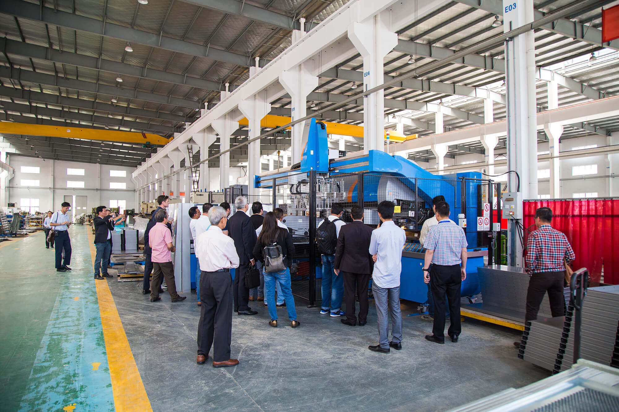 International visitors touring production line