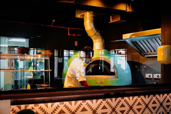 Pizza chain restaurant with oven-based ESP filtration system