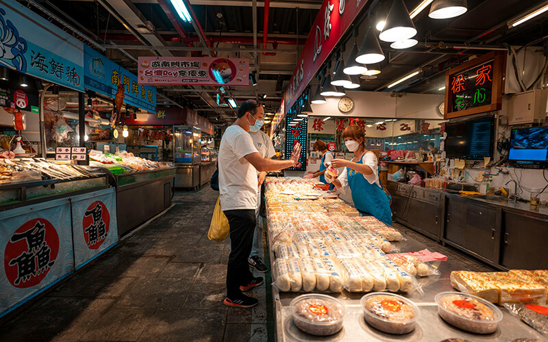 Hypermarket in-store deli with rotisserie display and compact above-ceiling ESP unit