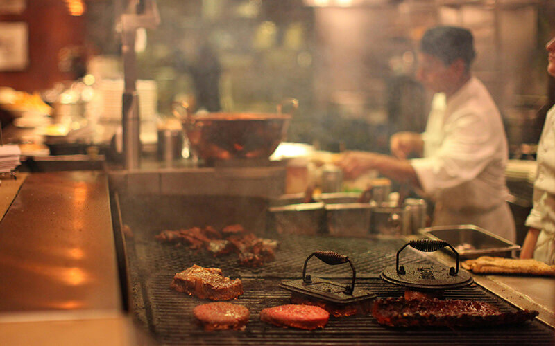 Western steakhouse charbroiler grill producing smoke for ESP filtration